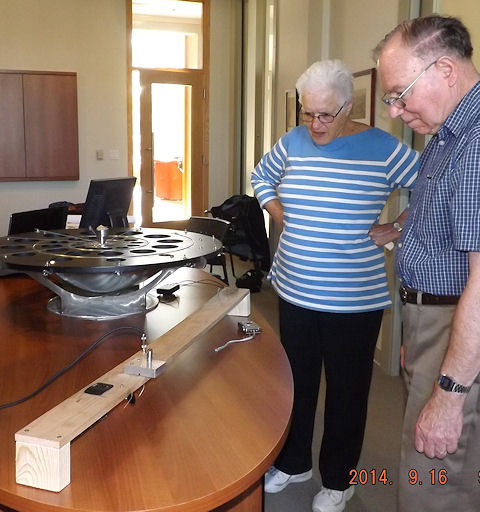 A person and person standing next to a table

Description automatically generated